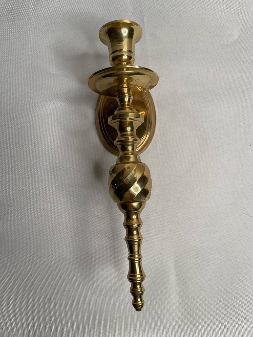 A Vintage solid brass wall sconce candle holder